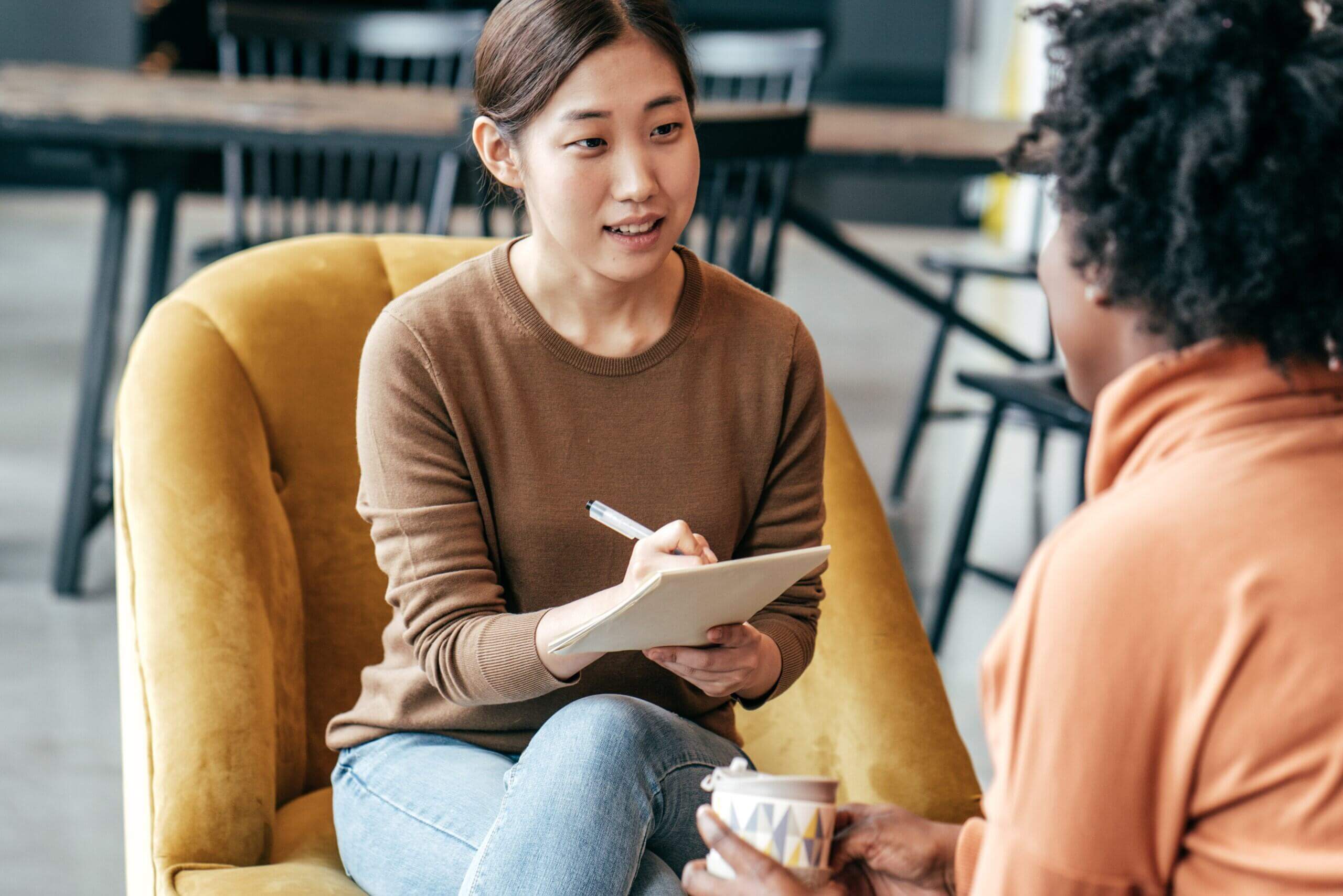 Women sitting in chair asking questions