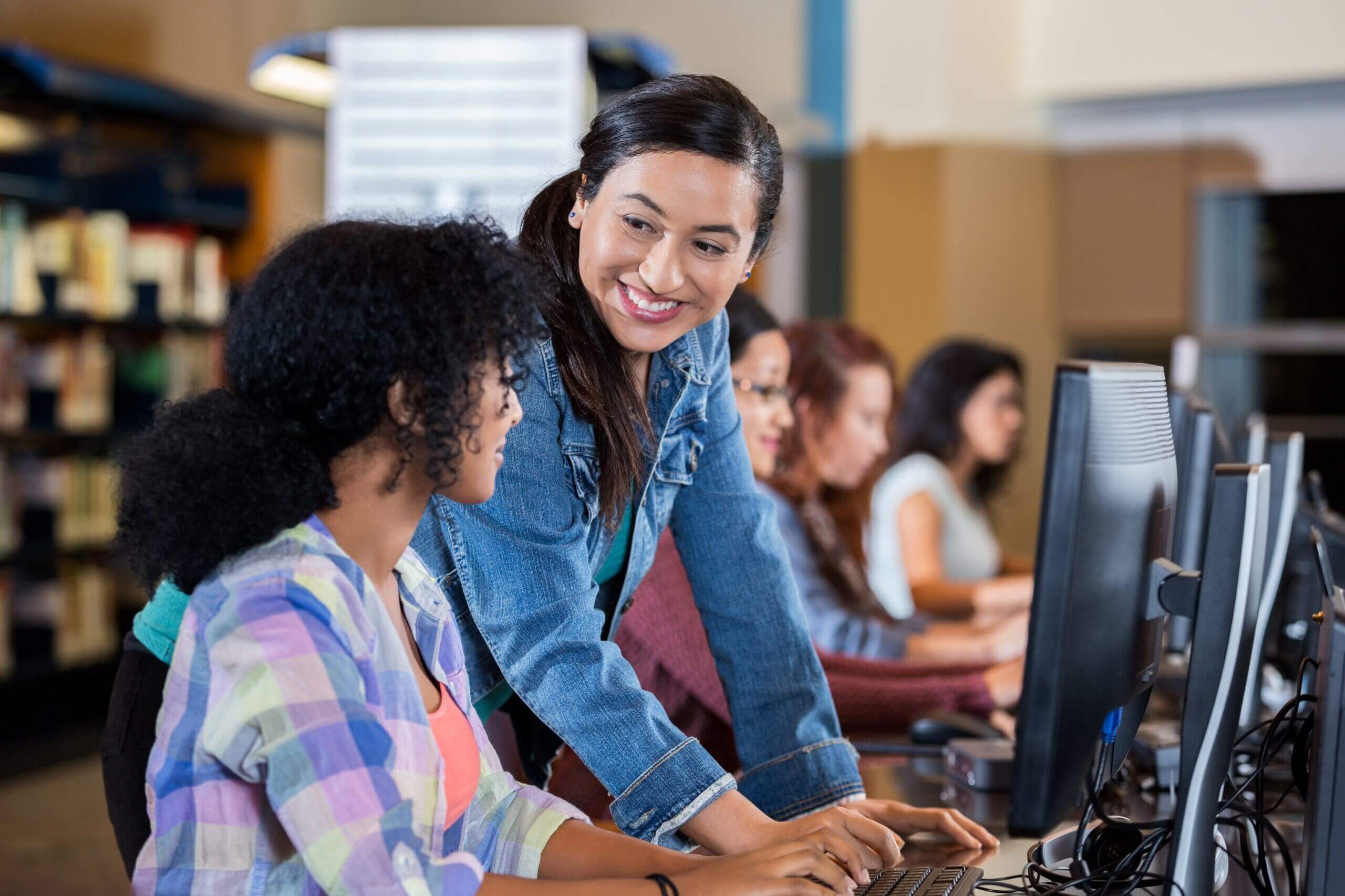 Women smiling and working on a computer