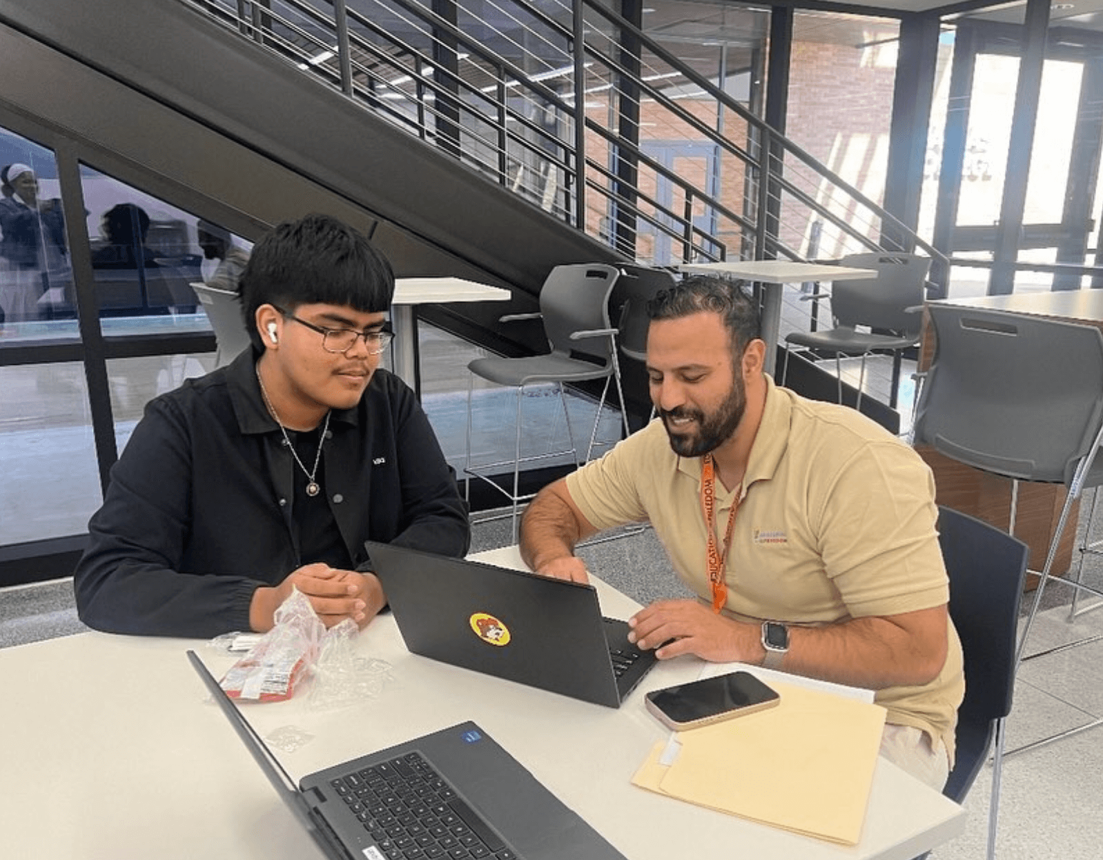 Two students working at table