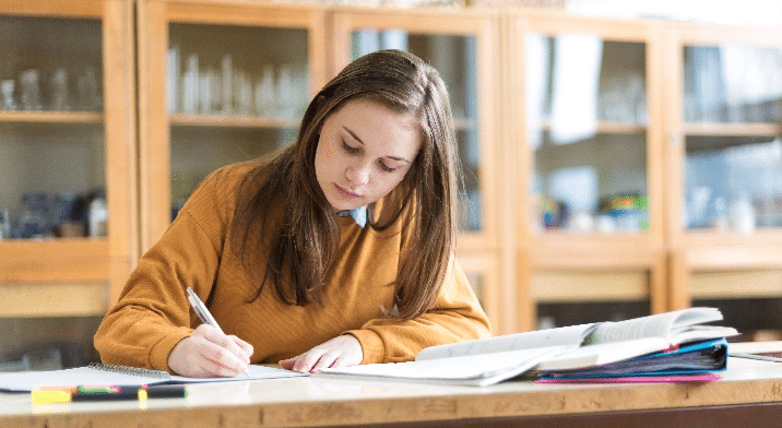 Student Working at A Desk in a Classroom
